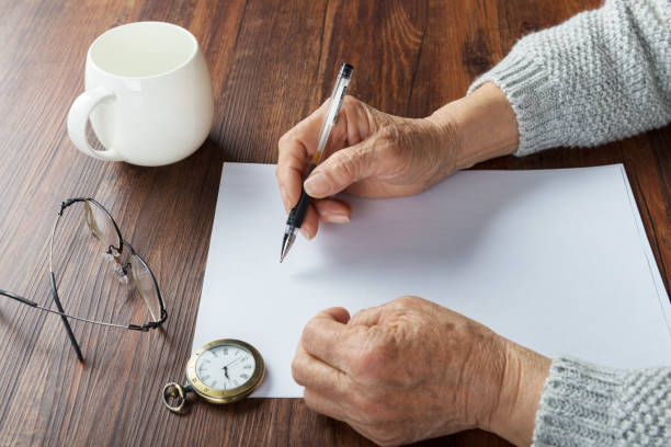 istock Old grandmother writing letters 987348734