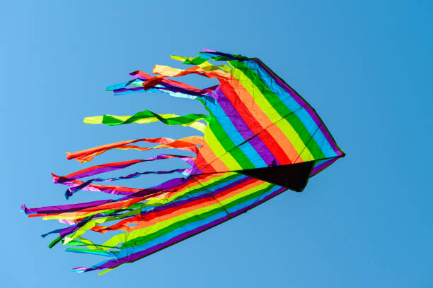 istock Colorful bright kite in the blue sky on summer day 987350884