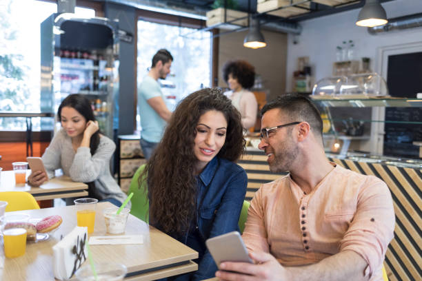 istock Tourists having breakfast and using smart phone 987353316