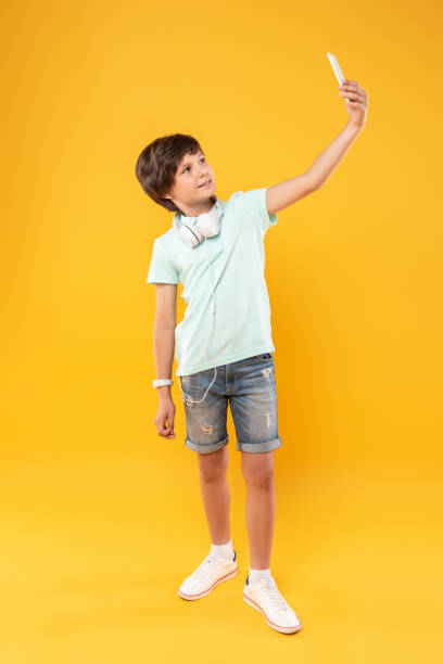 istock Smiling boy taking selfies and having fun 987359472