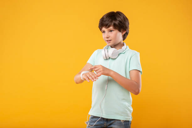 istock Thoughtful boy wearing a modern watch 987360026