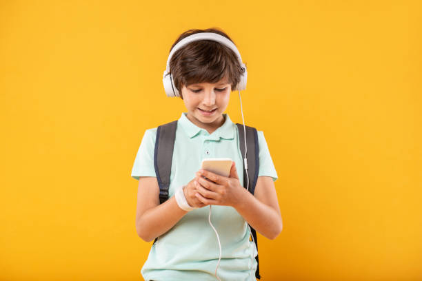 istock Content schoolboy listening to music 987365046