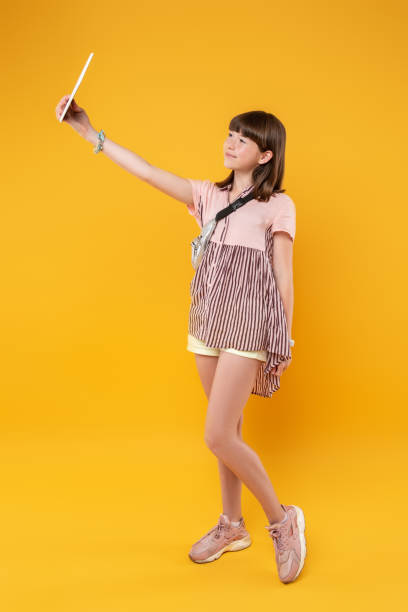 istock Inspired girl taking photos with her tablet 987366314