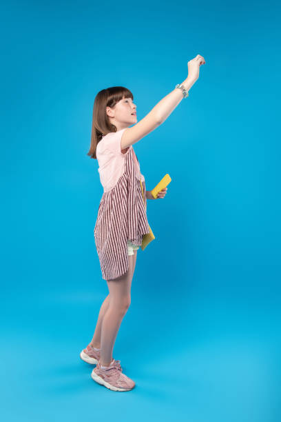 istock Merry girl writing on the board 987366990