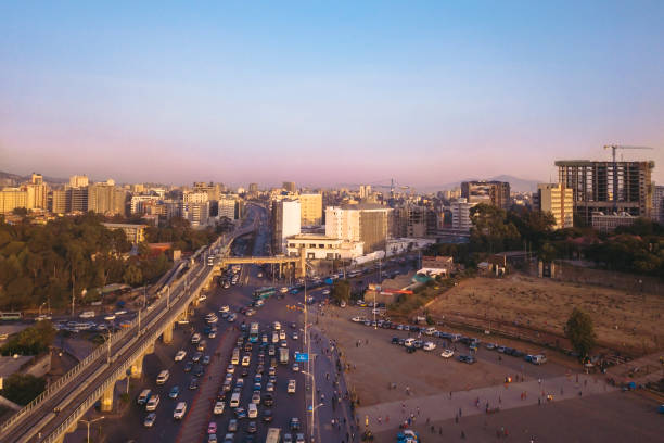 Meskel Square traffic in Addis Ababa from above Aerial view of the traffic in Meskel Square with new light rail system and sunset tones. Addis Ababa, Ethiopia. Captured with a drone. ethiopia city stock pictures, royalty-free photos & images