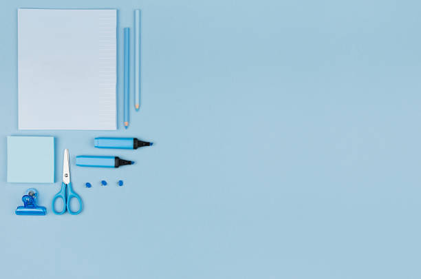 istock Blue office stationery collection on soft pastel blue paper  background, top view, copy space. 987378102