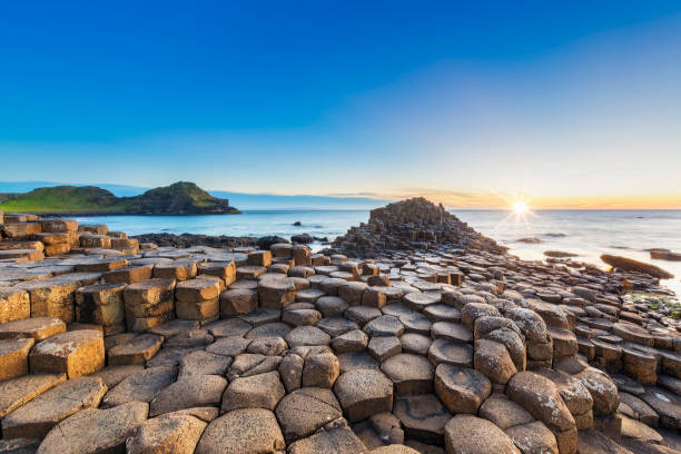 Sunset over Giants Causeway, Northern Ireland Sunset, Sunrise - Dawn, Sun, Stone - Object, National Landmark causeway photos stock pictures, royalty-free photos & images