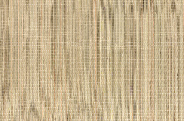 Beige natural mat of dry wicker grass as texture, background.
