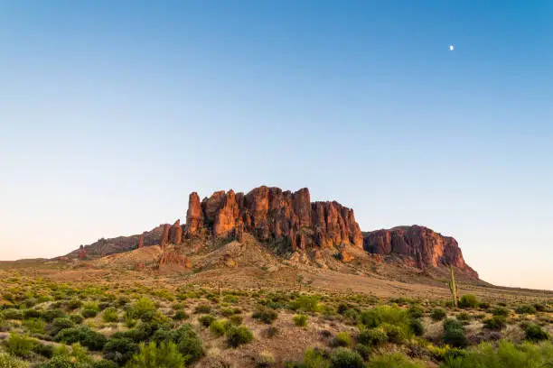 The moon rises over Superstition Mountain in Arizona.