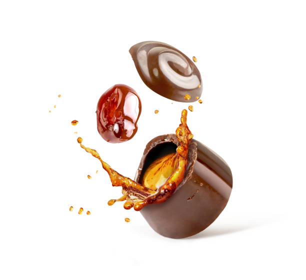 istock Chocolate sweets with cherries and cognac splashes isolated on white background 987384938