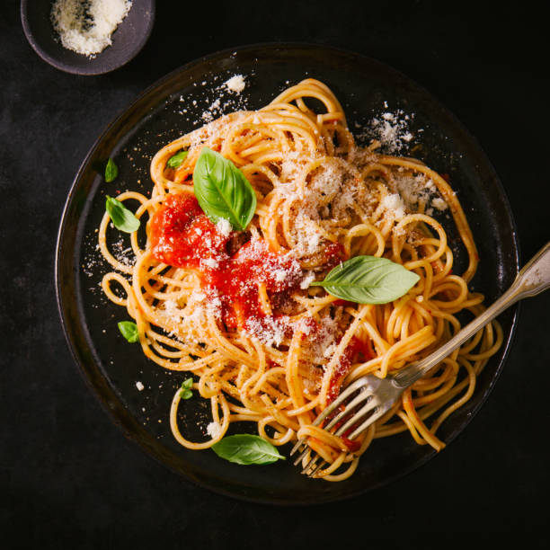 istock Dark plate with italian spaghetti on dark 987393154