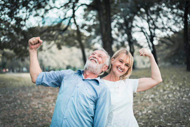 istock Happy elderly senior couple in park 987393370