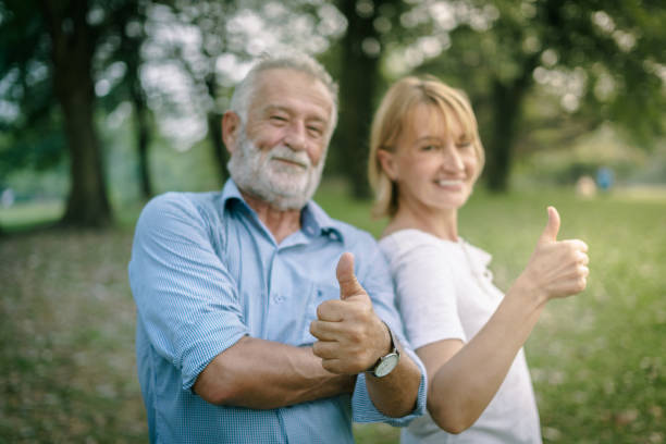 istock Happy elderly senior couple in park 987393436
