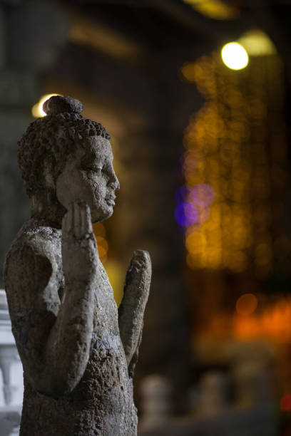 istock Old Buddha statue and city light background 987398232