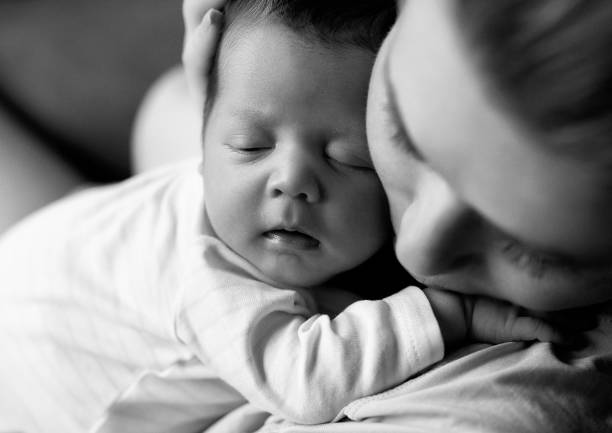 love my baby girl monochrome shot of mother embracing and loving her baby girl. photo taken indoors. babyhood photos stock pictures, royalty-free photos & images