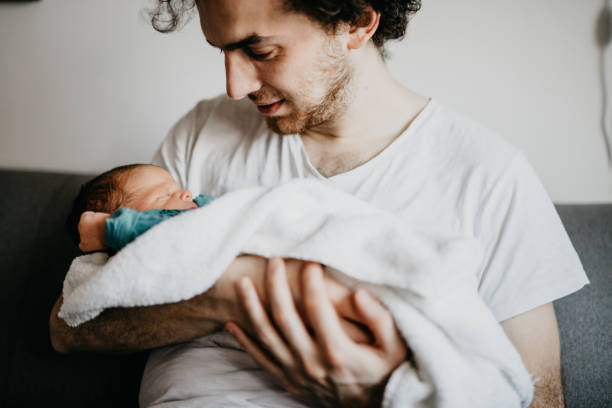 istock Dad embracing newborn baby boy 987412480