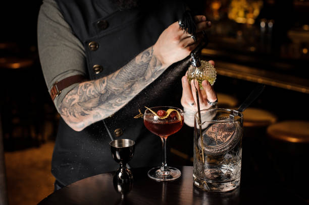 istock Professional bartender spraying on the delicious cocktail with a special liquid 987412586