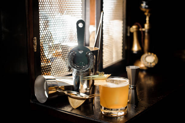 istock Yellow cocktail and essential barman equipment on the sill 987430264