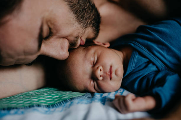 istock Dad kissing his sleeping baby son 987442686