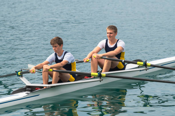 portrait of two young athletes in double scull rowing team - rowboat sport rowing team sports race imagens e fotografias de stock