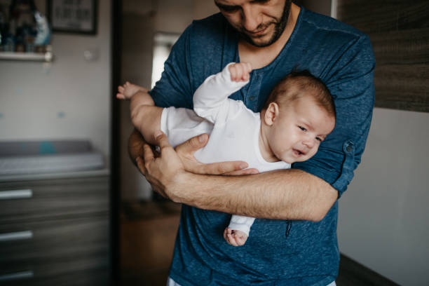 istock Dad holding crying colic baby 987442930