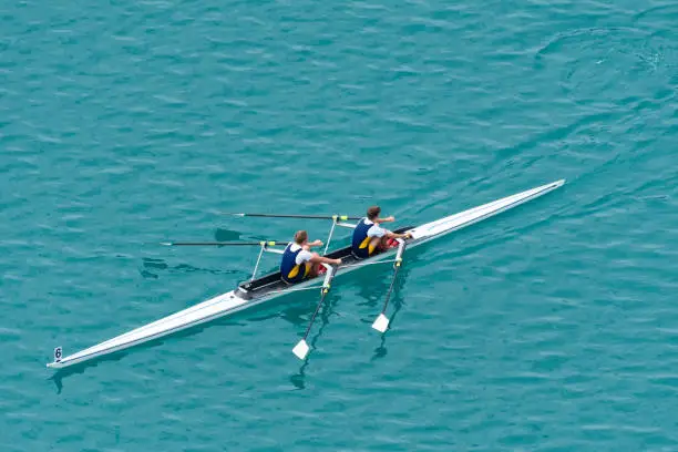 Upper view of double scull rowing team on the water, diagonal composition