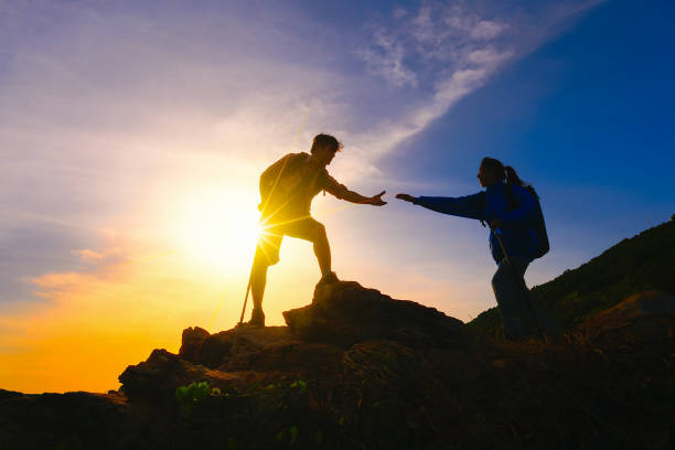 istock Couple climbing up on the mountain. 987451578