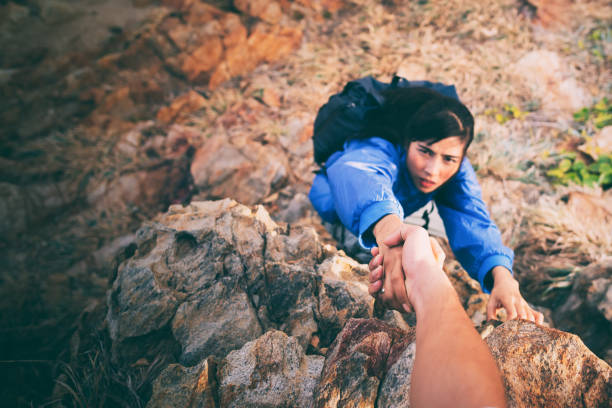 Adventurers helping asian woman.