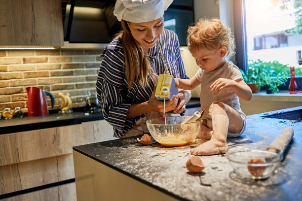 istock playful mother and her baby baking together 987452776