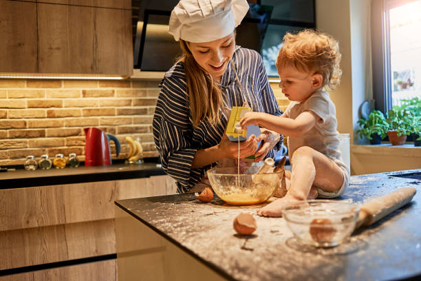 istock playful mother and her baby baking together 987452828