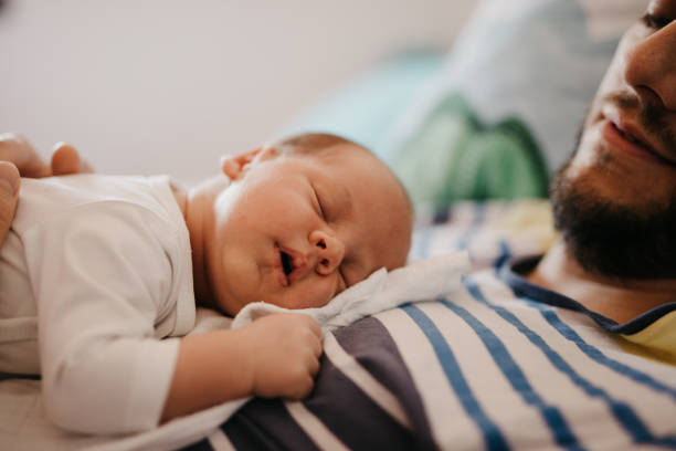 Father and baby son sleeping in bedroom Father and baby son sleeping in bedroom father and baby stock pictures, royalty-free photos & images