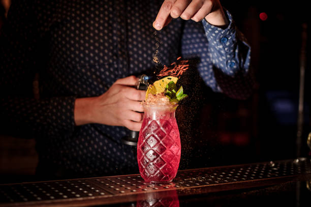 istock Bartender adding spices into the fresh and sweet strawberry mojito summer cocktail with a smoke note 987462684