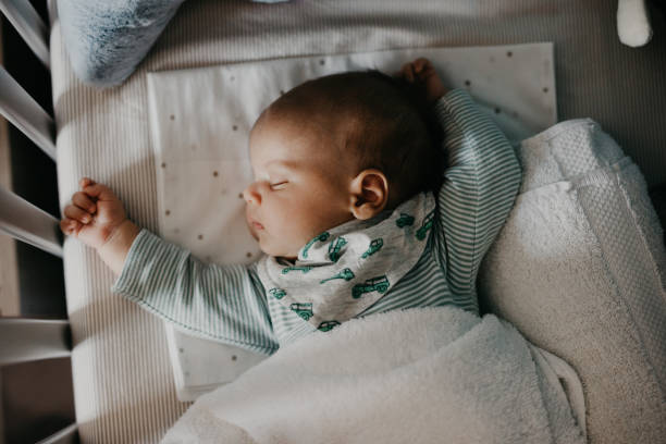 istock Cute little baby sleeping in Nursery Cot 987463048