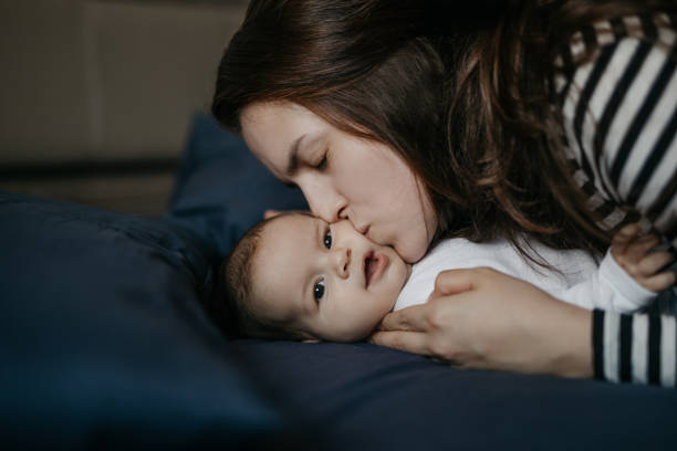 istock Mom kissing her baby 987463338