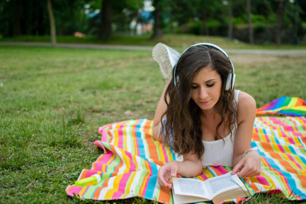 istock Relaxing in nature with book and music 987468672