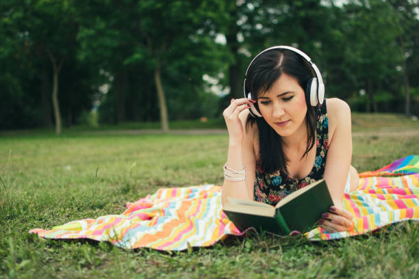 istock Relaxing in nature with book and music 987469802