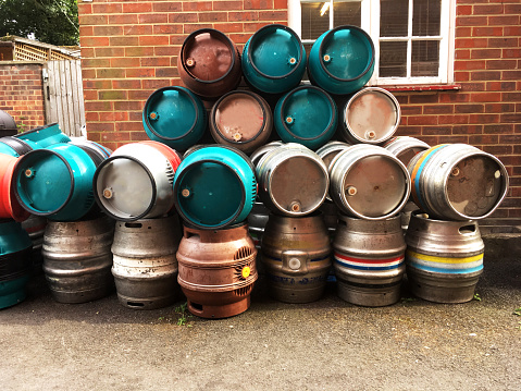 A Pile of Beer barrels Stacked Outside a Public House