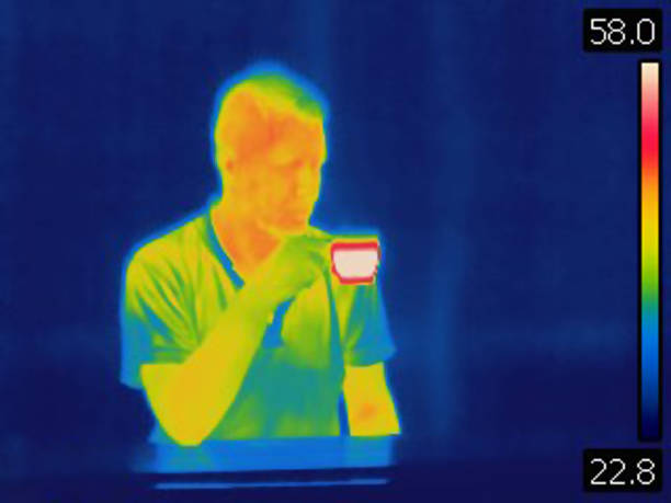 istock Thermal image of man drinking hot coffee. 987519844