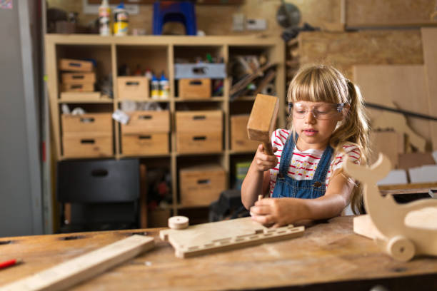 istock Young girl doing woodwork in a workshop 987520260