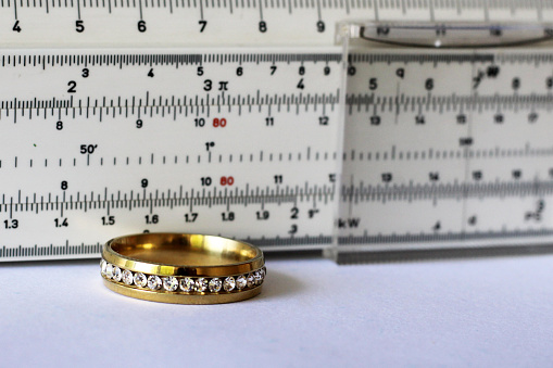 Gold ring with diamonds and a measuring instrument, the value of jewelry, object