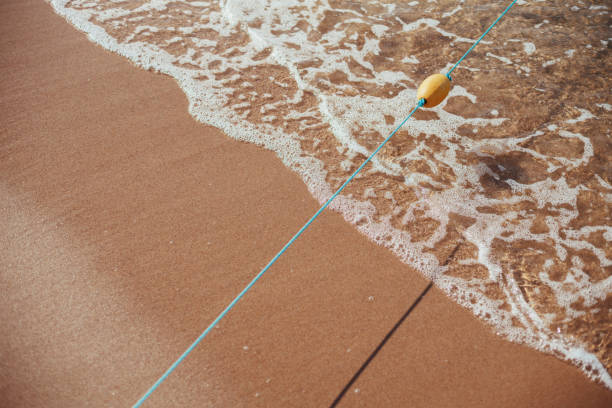 istock Soft wave of blue ocean on sandy beach. Background 987538914