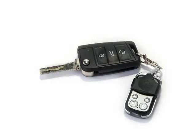 Car key with garage remote control on the white