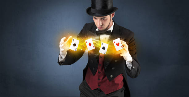 istock Illusionist making trick with magical play cards 987552752
