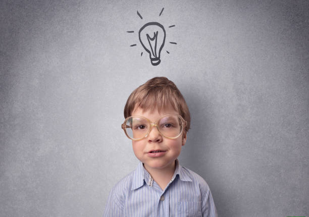 istock Smart kid in front of a drawn up grey wall 987553290
