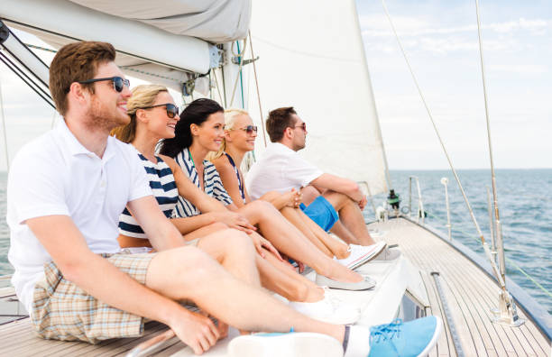 istock smiling friends sitting on yacht deck 987559294