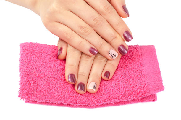 istock Beautiful female hands with manicure on pink. 987559750