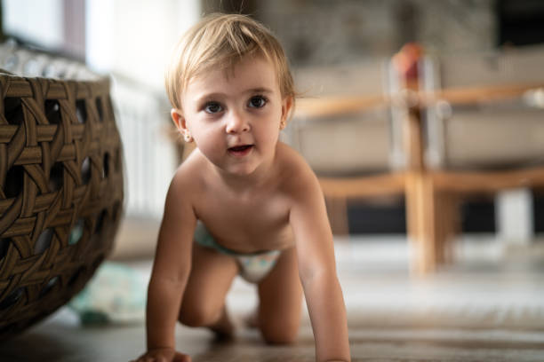 Baby crawling by herself at home