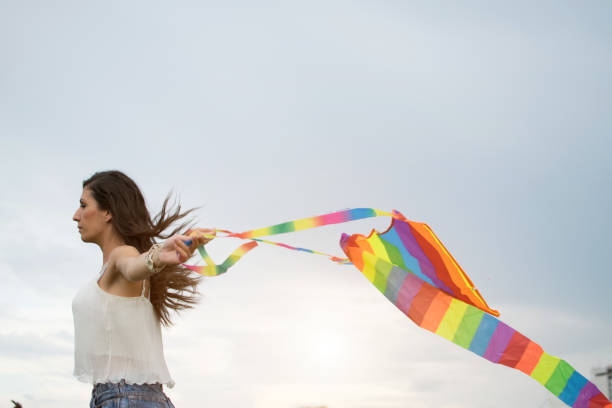 istock Happy girl launching kites 987564190