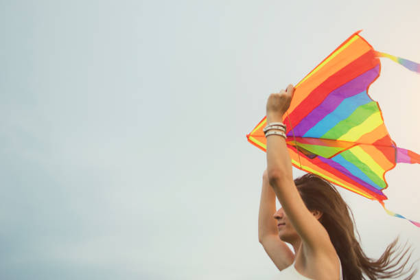 istock Happy girl launching kites 987564576