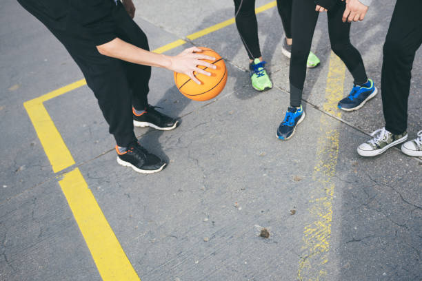 istock playing basketball on street together 987567882
